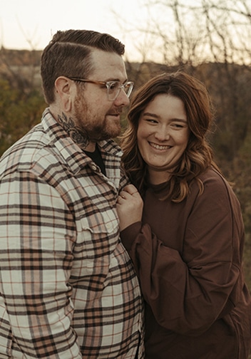 Rebecca and Andrew sharing joy about adopting in a field
